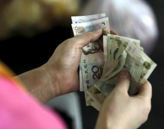 China's yuan slips on pre-holiday dollar demand despite intervention